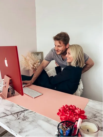Tyler and Shay, the husband-and-wife team behind Built by Vision, working together at their desk