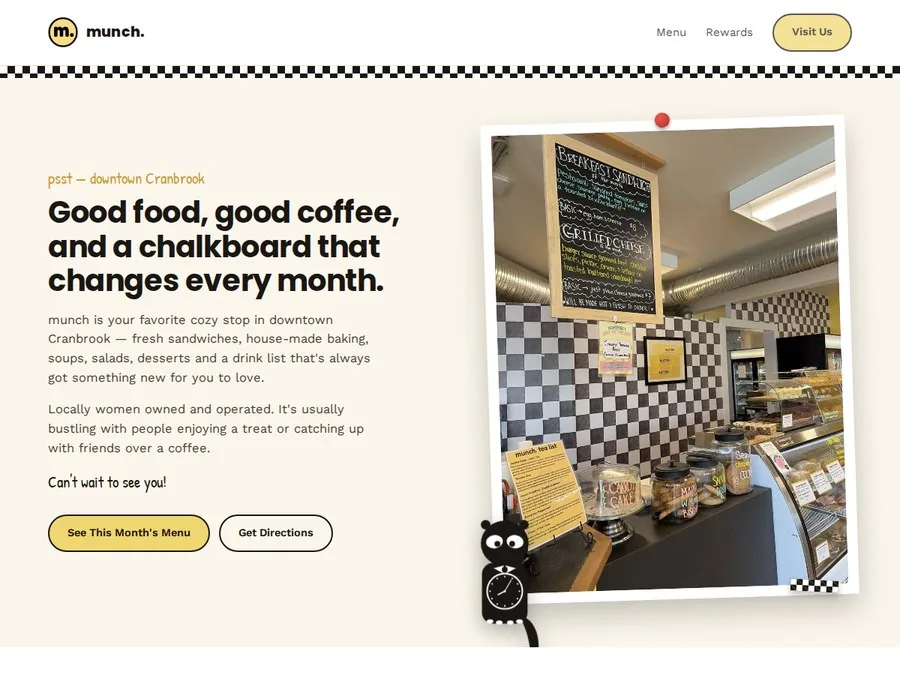 Munch Cafe website hero, a photo of the cafe counter under the chalkboard menu